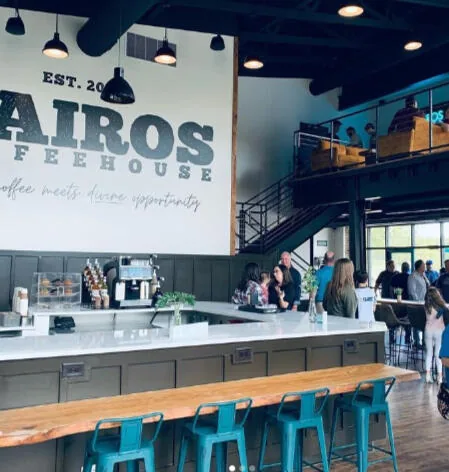 The Kairos Coffeehouse counter beneath the est. 2022 sign