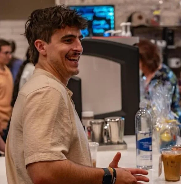 A guest laughing at the Kairos counter