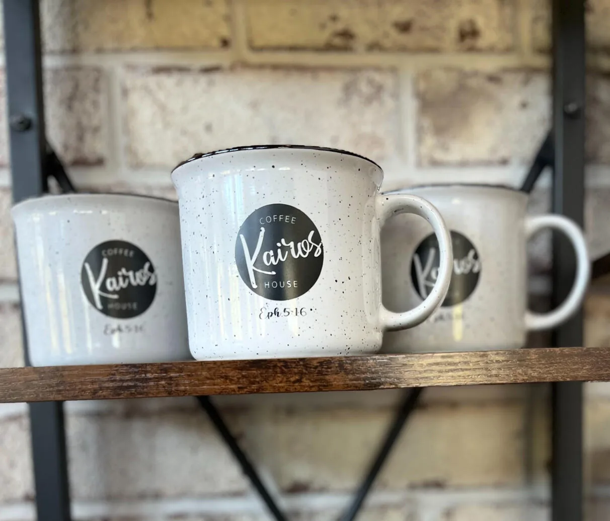 Kairos Coffeehouse mugs on a shelf