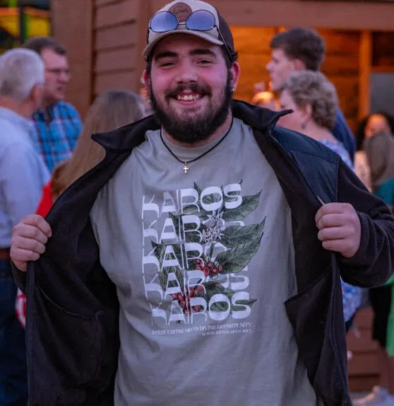 A guest showing off a Kairos Coffeehouse shirt
