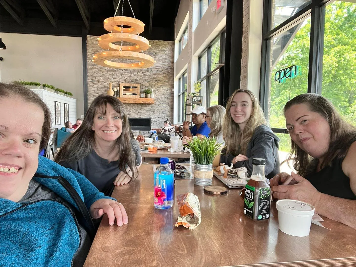 Friends gathered around a table at Kairos Coffeehouse