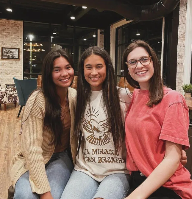 Three friends together at Kairos Coffeehouse