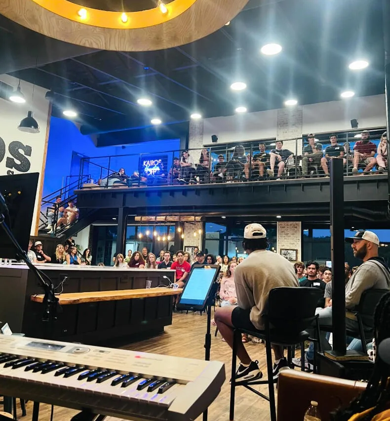 A packed worship night seen from the Kairos balcony