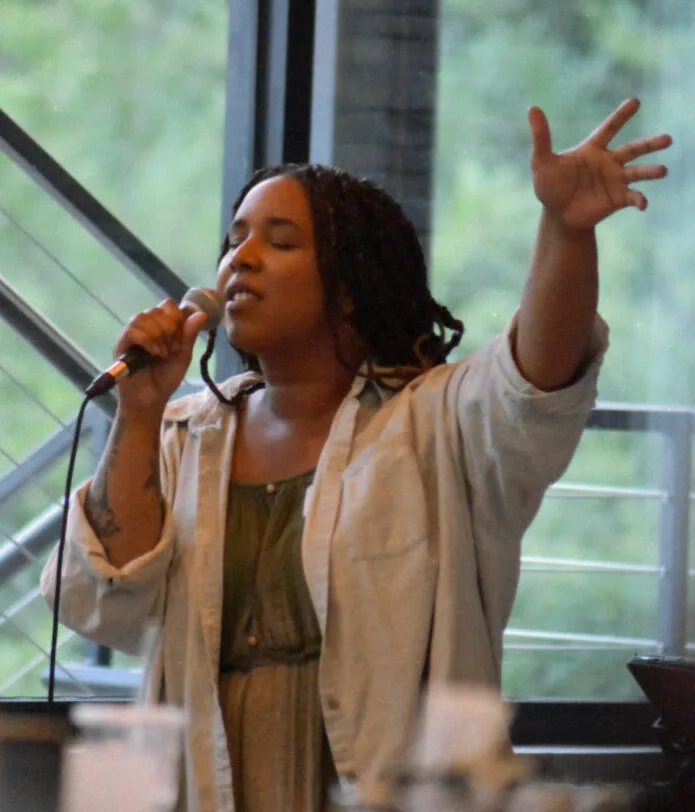 A young adult leading worship at Kairos
