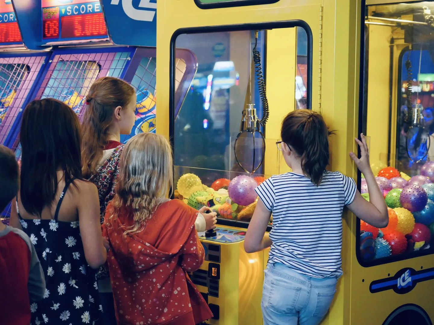 Kids at the claw machine at The Landing