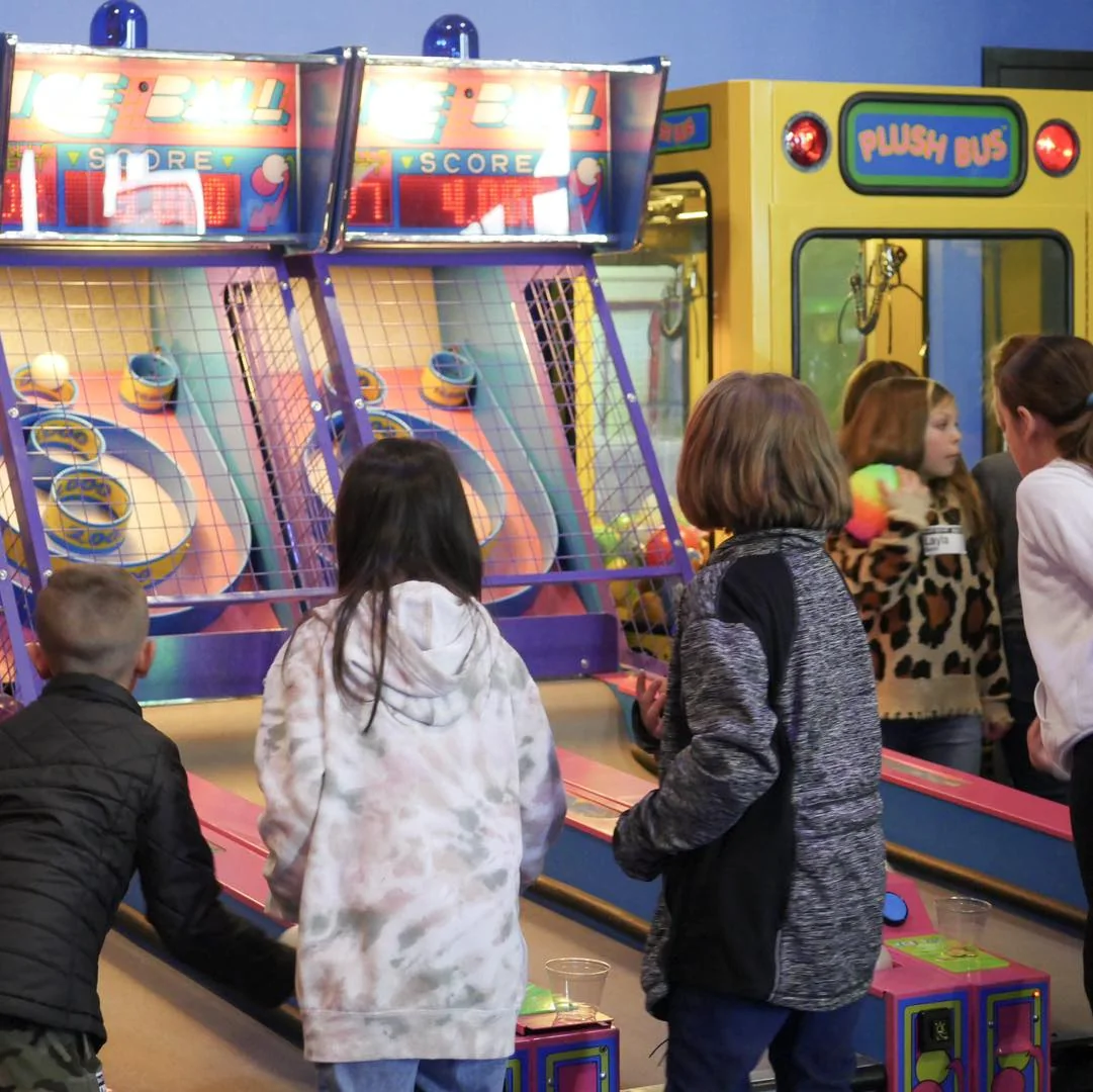 A teen playing skeeball at The Landing