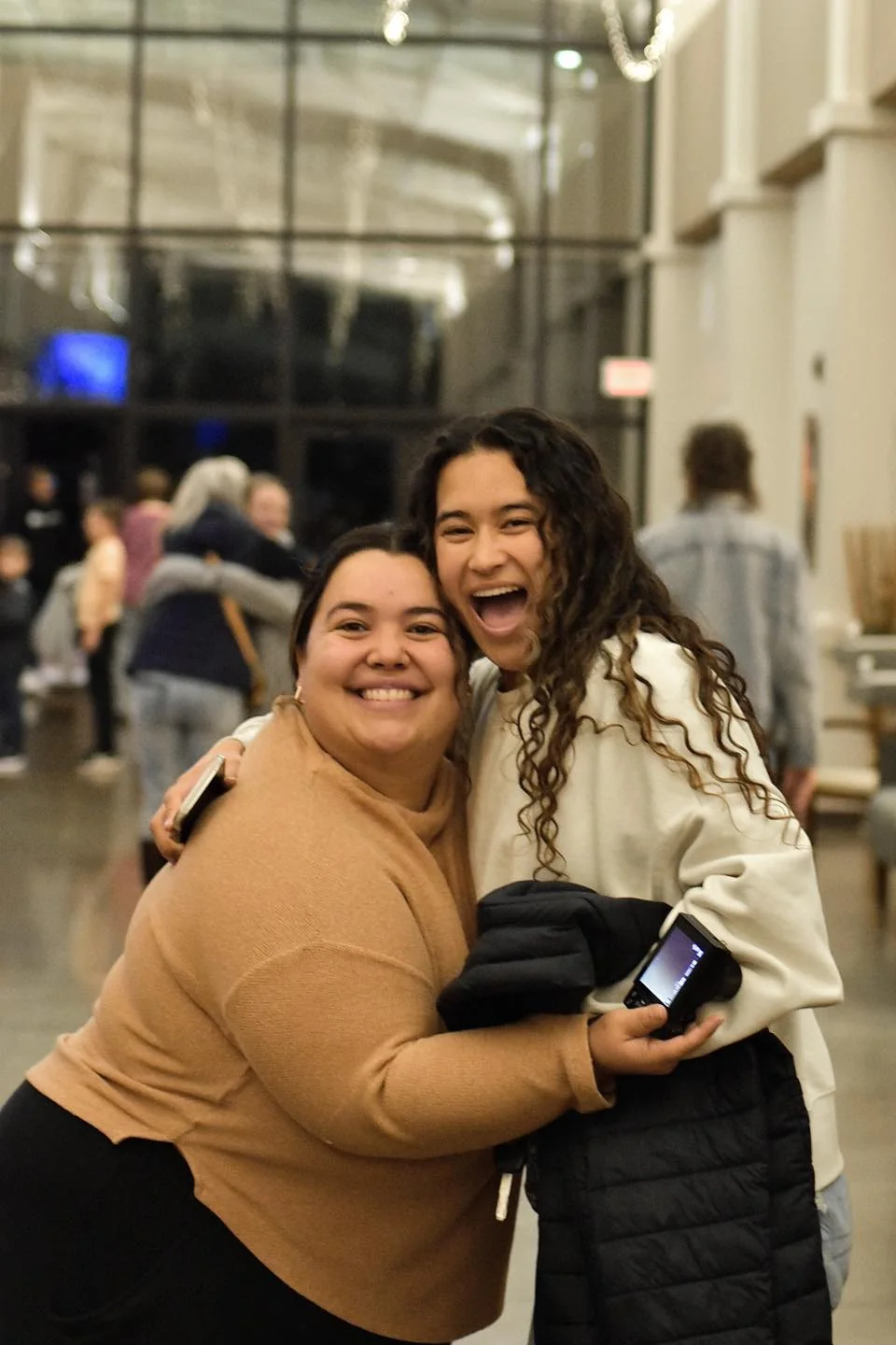 Friends hugging in the Joy Church lobby