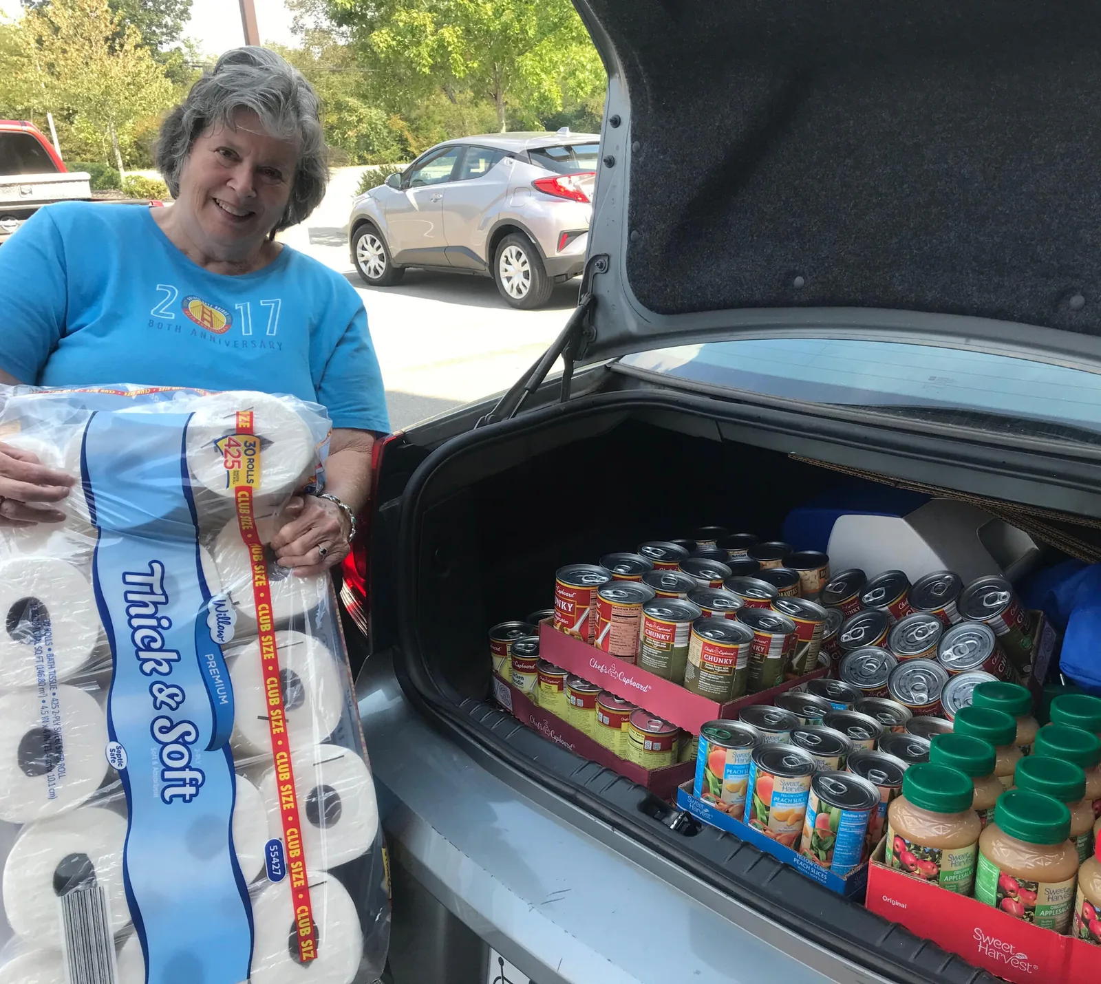 A donor delivering groceries from her car