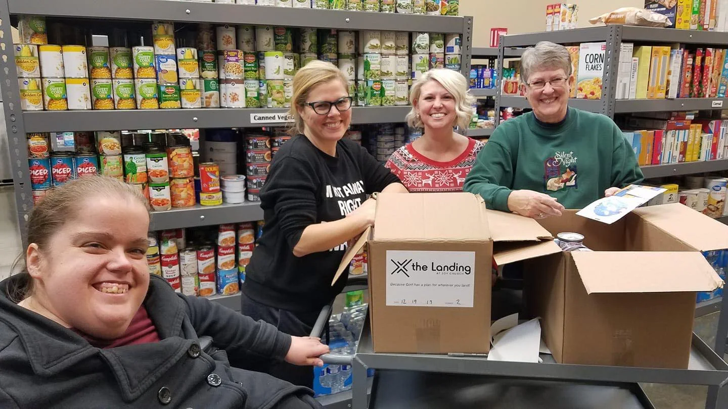 Volunteers packing a food box at The Pantry