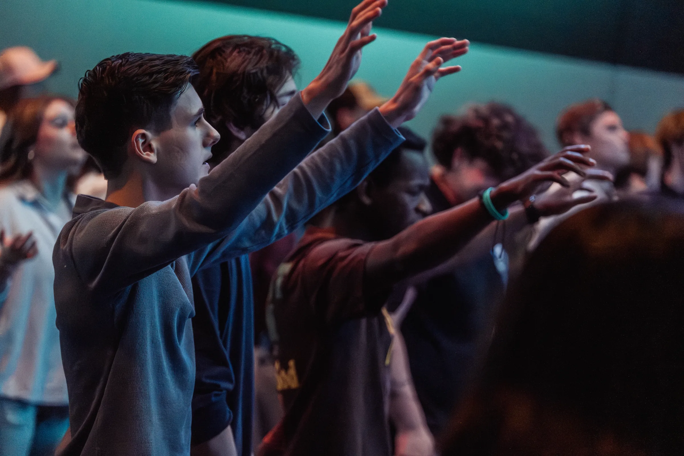 Students worshipping with hands raised