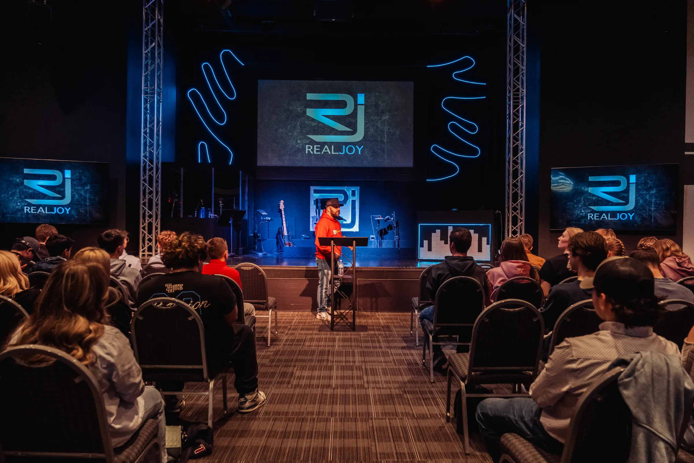 The RealJoy room with the RealJoy logo on every screen