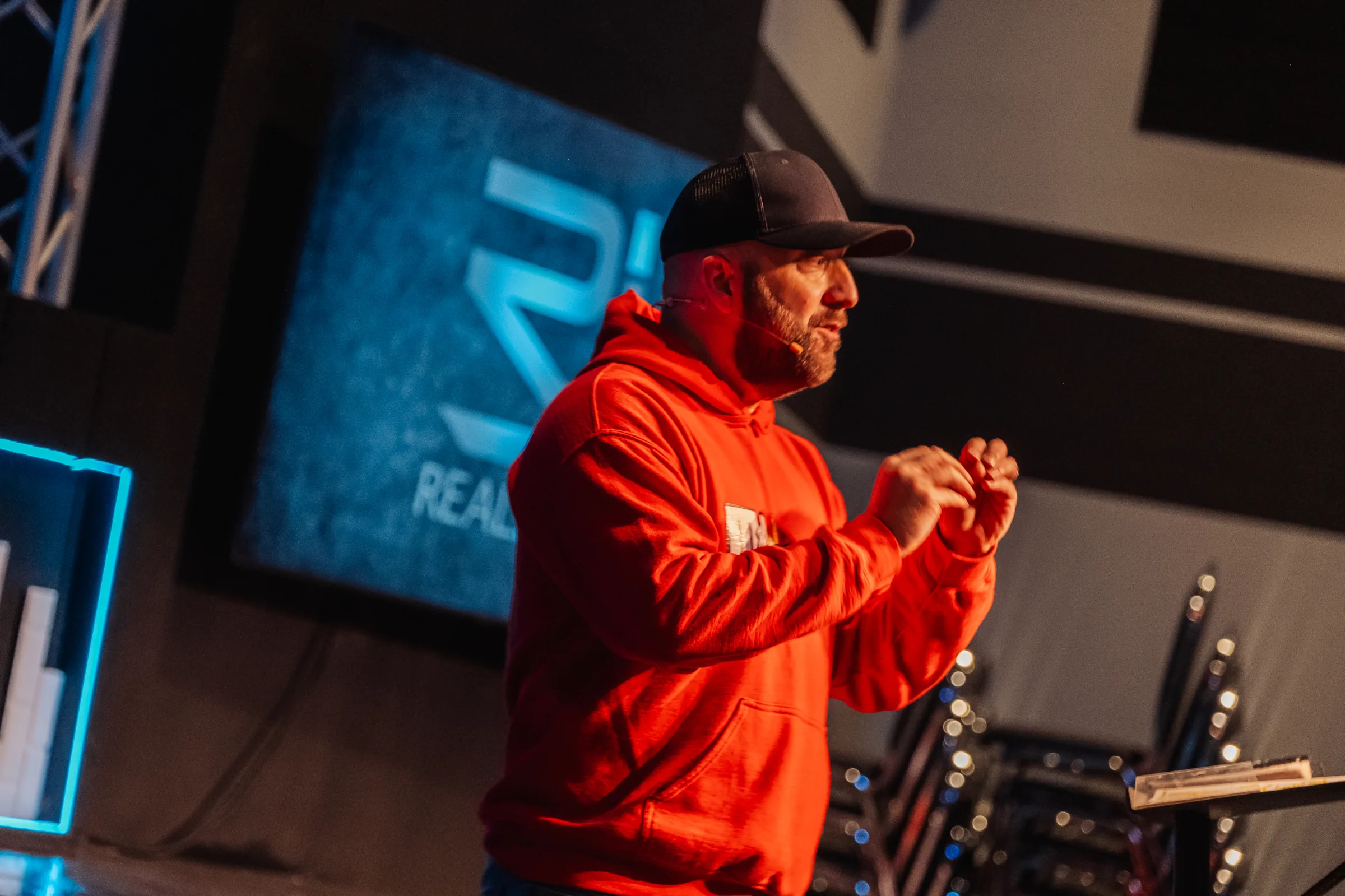 Pastor teaching in front of the RealJoy logo