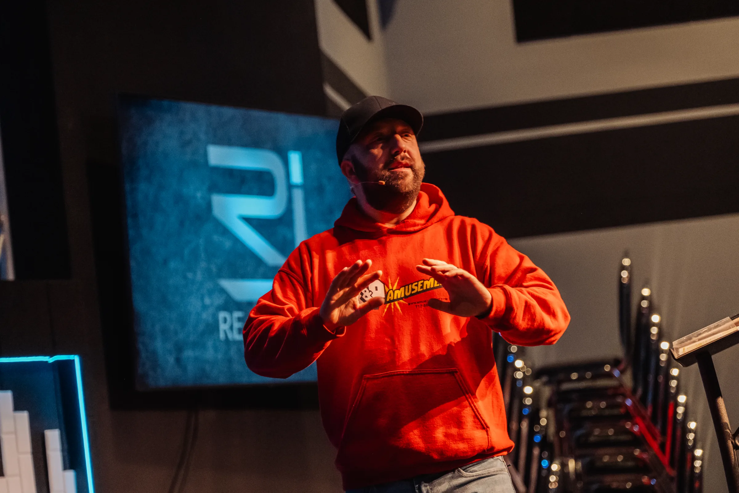 Pastor teaching in front of the RealJoy logo